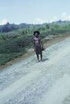 A Wapenamanda man walking to the district office, wig wearer, May 1963