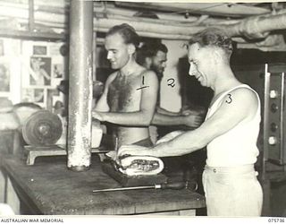 AT SEA. 1944-08/09. COOKS IN THE GALLEY OF THE RAN CORVETTE, GEELONG PREPARE A MEAL AS THE VESSEL PROCEEDS ALONG THE COAST OF NEW GUINEA