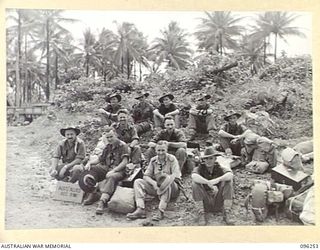 JACQUINOT BAY, NEW BRITAIN. 1945-09-09. MEMBERS OF THE AUSTRALIAN PRISONER OF WAR RECOVERY UNIT, UNDER THE COMMAND OF MAJOR L.F. DARLING, AWAITING EMBARKATION ON HMAS MANOORA. THEY ACCOMPANIED THE ..