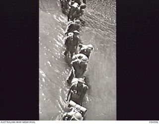 GILI GILI, NEW GUINEA, 1943-07-15. TROOPS OF THE 29TH AUSTRALIAN INFANTRY BRIGADE, 5TH AUSTRALIAN DIVISION, EMBARKING ON AN AMERICAN LCI (LANDING CRAFT INFANTRY) FOR THEIR MOVE FROM GILI GILI TO ..