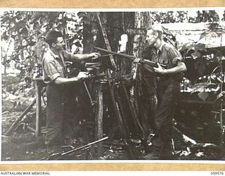 FINSCHHAFEN AREA, NEW GUINEA, 1943-10-28. NX26927 SERGEANT F.A. MILLICAN OF SYDNEY, NSW (1) (LEFT), AND NX27687 SERGEANT G.A. BENDALL OF INGLEBURN, NSW (2), ARMOURERS OF THE 2/2ND AUSTRALIAN ..