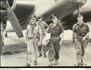 TADJI NEAR AITAPE, NORTH EAST NEW GUINEA. 1945-01-08. BEAUFORT BOMBER CREW RETURNING FROM AN AIR STRIKE ON WEWAK, WHICH HAS BEEN BADLY BATTERED BY THE RAAF. LEFT TO RIGHT: PILOT OFFICER R. MAYNARD, ..