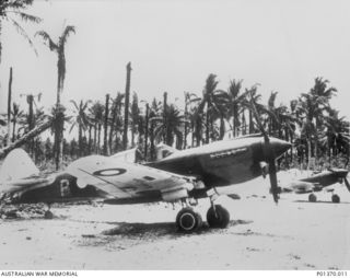 MILNE BAY, PAPUA. 1943. CURTISS P-40E KITTYHAWK FIGHTER AIRCRAFT OF NO. 77 SQUADRON RAAF IN THE DISPERSAL AREA AT GURNEY STRIP, MILNE BAY, FROM WHICH THE SQUADRON OPERATED. THE PHOTOGRAPH WAS TAKEN ..