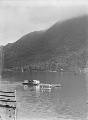[View of a barge being towed through the water]