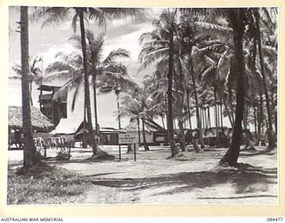 LAE, NEW GUINEA. 1944-12-18. THE ADMINISTRATION OFFICES AND THE SIGNAL TOWER AT HQ 12 SMALL SHIP COY. THE SITE, SITUATED WITHIN 20 FEET OF HIGH TIDE, IS THE THIRD OCCUPIED BY THE COY. THE OTHERS ..