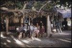 Ann and Roy Rappaport with Poia's family in an open-sided house, Moorea