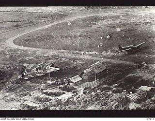 VUNAKANOU, NEW GUINEA. 1943-11-02. VIEW FROM FIFTH AIR FORCE, UNITED STATES ARMY AIR FORCE BOMBER OF THE PERIMETER OF THE AIRSTRIP. IN FOREGROUND, BULLETS FROM ATTACKING AIRCRAFT CAN BEEN SEEN ..