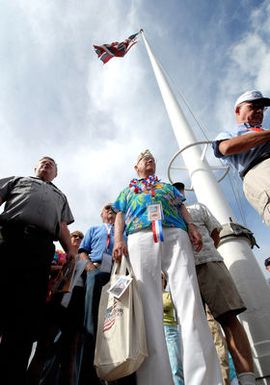 U.S. Navy Pearl Harbor survivor, retired CAPT. Jack Evans stands in front of the original flagpole on Hickam Air Force Base (AFB), which stood during the 1941 attack as the American flag remained flying even though torn by bullets and shrapnel. Evans was taking part on Dec. 3, 2006, in a joint U.S. Navy/National Park Service ceremony commemorating the 65th anniversary of the attack on Pearl Harbor, Hawaii