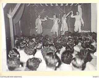 LAE AREA, NEW GUINEA, 1945-07-09. THE MALE BALLET ACT DURING THE REVUE "OVER TO YOU" STAGED BY 19 LINES OF COMMUNICATION AREA SIGNALS. IT WAS HELD IN THE UNIT'S RECREATION HUT WHICH WAS KNOWN FOR ..