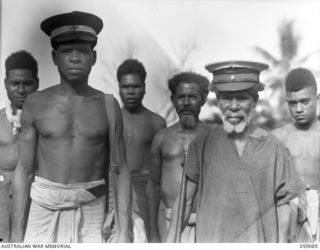 BUKAUA, NEW GUINEA. 1943-10-18. DAHU (1) PARAMOUNT CHIEF OF THE BUKAUA DIVISION, MARKHAM ADMINISTRATION DISTRICT (RIGHT) AND DANANDU (2) THE VILLAGE TULTUL AND MEDICAL ORDERLY - DOCTOR BOY IN ..