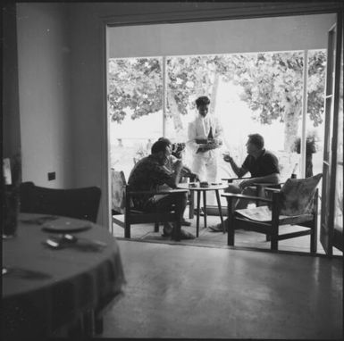 Drinks being served to a group of people on a verandah of a hotel, Taveuni, Fiji, 1966 / Michael Terry