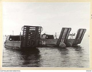 PURUATA ISLAND, SOUTH BOUGAINVILLE. 1945-05-29. AUSTRALIAN LANDING CRAFT 15'S OF 42 LANDING CRAFT COMPANY, TIED TO A BUOY AWAITING REPAIR. THIS COMPANY HAS PLAYED AN IMPORTANT PART IN SUPPLYING ..