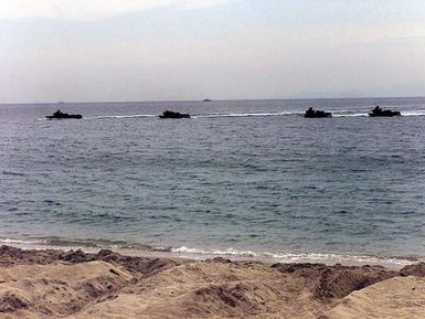 Amphibious Assault Vehicles attached to 3rd Battalion 7th Marines Lima Company off the USS Frederick, a Landing Ship Tank (LST) stationed in Pearl Harbor, Hawaii, storm the beach, during a Philippine Marine beach raid at Ternate, Republic of the Philippines, during Exercise BALIKATAN 2001. Exercise BALIKATAN is a combined joint exercise of the Republic of Philippines and the United States. The exercise demonstrates the U.S. resolve to support the Philippines against external aggression consistent with the Mutual Defense Treaty between both nations