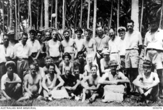 EMIRAU ISLAND. GROUP PORTRAIT OF SOME OF THE PASSENGERS AND CREW WHO HAD BEEN CAST AWAY ON EMIRAU ISLAND IN THE BISMARCK ARCHIPELAGO AFTER THEIR MERCHANT SHIPS WERE SUNK BY GERMAN RAIDERS KOMET AND ..