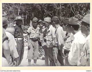 FAURO ISLAND, BOUGAINVILLE AREA. 1945-11-11. JAPANESE OFFICERS OF NO. 9 JAPANESE AREA MEET LIEUTENANT COLONEL H.L.E. DUNKLEY, COMMANDING OFFICER, 7 INFANTRY BATTALION PRIOR TO HIS INSPECTION OF THE ..