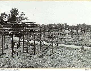 LAE, NEW GUINEA. 1944-03-30. A GENERAL VIEW OF NEW STOREHOUSES UNDER CONSTRUCTION AT NO. 2 SUB DEPOT, 103RD FIELD AMMUNITION DEPOT