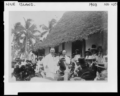Creator unknown: Hon C H Mills presenting New Zealand Ensign, Niue