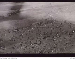 DUMPU, RAMU VALLEY, NEW GUINEA. 1944-02-10. AN AERIAL VIEW TAKEN FROM A HEIGHT OF 300 FEET OF THE GENERAL AREA AT 7TH DIVISION SIGNAL HQ, LOOKING TOWARDS THE NORTH EAST, AND SHOWING URIA RIVER ..