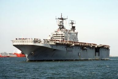 A port bow view of the amphibious assault ship USS SAIPAN (LHA-2) approaching Naval Station, Norfolk