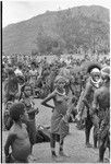 Government-sponsored festival in Tabibuga: crowd of people, patrol officer Jack Edwards in distance