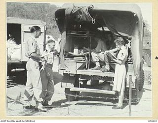 ON ARRIVAL AT THE 2/1ST AUSTRALIAN GENERAL HOSPITAL PATIENTS PARTICULARS ARE NOTED AT THE MEDICAL INSPECTION CENTRE. MEMBERS OF THE HOSPITAL STAFF ARE PICTURED TAKING DETAILS FROM A PATIENT IN THE ..