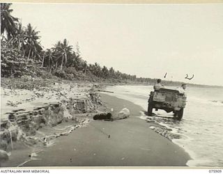 HANSA BAY, NEW GUINEA. 1944-09-06. AUSTRALIAN ARMY PERSONNEL DRIVING THEIR JEEP ALONG THE BEACH IN PREFERENCE TO THE INLAND ROAD. IN THE JEEP ARE: VX89946 GUNNER H.J. SWIFT, 2/14TH FIELD REGIMENT ..