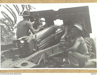DONADABU AREA, NEW GUINEA. 1943-12-01. NO. 4 GUN OF THE 2/4TH AUSTRALIAN FIELD REGIMENT AT FULL RECOIL DURING THE COMBINED EXERCISE WITH THE 2/10TH AUSTRALIAN INFANTRY BATTALION. SHOWN ARE: NX98996 ..