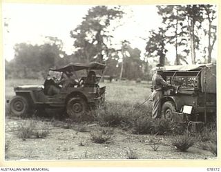 LAE, NEW GUINEA. 1945-01-03. QX39369 CORPORAL G.C. FINDLAY (1) AND NX140638 SIGNALLER J.H. BULL (2), 34TH WIRELESS TELEGRAPHY SECTION (HEAVY) WORKING ON THE SETTING UP OF A MOBILE RADIO STATION FOR ..