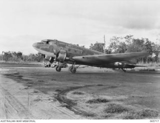 MAREEBA, QLD. 1944-04-10. THE DOUGLAS C47 AIRCRAFT, MILITARY VERSION OF THE DC3 AIRLINER, "IRENE" (CALL SIGN VH-CFB) OF THE UNITED STATES ARMY AIR FORCE, WITH AN ALL-AMERICAN CREW, ON THE AIRSTRIP ..