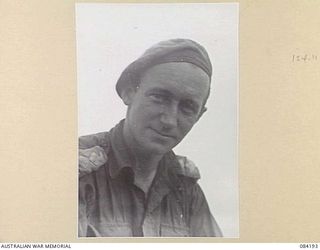 SUAIN PLANTATION, NEW GUINEA. 1944-12-09. CAPTAIN A.R. TOLMER, NEW GUINEAN INFANTRY BATTALION, AT BATTALION HQ, 2/4 INFANTRY BN. AN ORIGINAL MEMBER OF THE 2/22 INF BN CAPTURED DURING THE JAPANESE ..