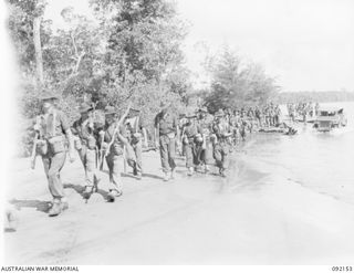 WEWAK AREA, NEW GUINEA. 1945-05-13. TROOPS OF 2/8 INFANTRY BATTALION MARCHING ALONG BORAM BEACH NEAR WEWAK ON THEIR WAY TO RELIEVE THE 2/4 INFANTRY BATTALION. IDENTIFIED PERSONNEL ARE:- PRIVATE ..