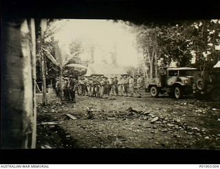 Lae, New Guinea. c. 1944-05. Members of No 1 Section, Detached, 2 Aust Field Survey Company, on parade at Main Camp, Bitibum Road