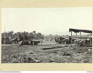 LAE, NEW GUINEA. 1944-03-24. A SECTION OF THE TEMPORARY TENT LINES AND BLACKSMITH'S SHOP ERECTED BY AN ADVANCE PARTY OF THE 2/7TH ADVANCED WORKSHOP, AUSTRALIAN ELECTRICAL AND MECHANICAL ENGINEERS