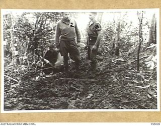 FARIA VALLEY, NEW GUINEA, 1943-10-17. TROOPS OF THE 2/16TH AUSTRALIAN INFANTRY BATTALION ON A MUDDY TRACK NEAR JOHN'S KNOLL. LEFT TO RIGHT:- WX8036 PRIVATE R.F. ANDERSON; WX8242 ACTING CORPORAL G. ..