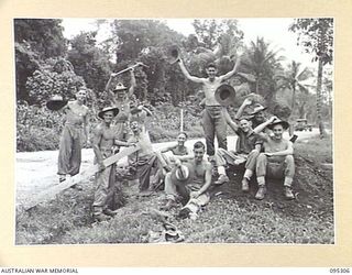 PALMALMAL PLANTATION, JACQUINOT BAY, NEW BRITAIN, 1945-08-15. ROAD WORKING PARTY 29/46 INFANTRY BATTALION REACT HAPPILY AT NEWS OF THE CAPITULATION OF JAPAN