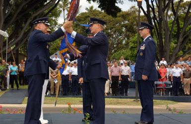 US Air Force (USAF) General (GEN) William J. Begert relinquishes command and hands CHIEF of STAFF USAF (CSAF), GEN John P. Jumper the Pacific Air Forces (PACAF) flag during the Change of Command and Retirement Ceremony for GEN William J. Begert, Commander, Pacific Air Forces, Hickam Air Force Base (AFB), Hawaii (HI)