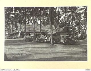 MILNE BAY, NEW GUINEA, 1944-02-10. THE HEADQUARTERS, MILNE BAY BASE SUB AREA. THE NATIVE BUILDING ON THE LEFT IS THE "Q" STORE. THIS BLOCK STANDS ON THE SITE OF THE 5TH DIVISION "A" AND "Q" ..