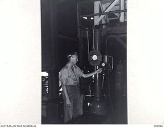 RABAUL, NEW BRITAIN, 1946-03-29. PRIVATE B. MCDERMOTT OPERATING THE CARBONATER AT THE AUSTRALIAN ARMY CANTEENS SERVICE CORDIAL FACTORY. THE FACTORY, STAFFED BY SEVEN SKILLED ARMY PERSONNEL, A ..