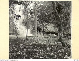 KILIGIA, NEW GUINEA. 1944-04-08. NATIVES AT HEADQUARTERS 5TH DIVISION BURNING LEAVES AND GRASS AT THE SITE OF AN OFFICERS MESS WHICH IS UNDER CONSTRUCTION. TREES HAVE BEEN CLEARED SO THAT THE BLACK ..