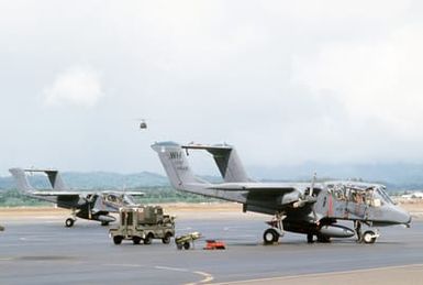 Right front view of two OV-10 Bronco aircraft from the 22nd Tactical Air Support Squadron, as pre-flight operations take place during Exercise OPPORTUNE JOURNEY 84