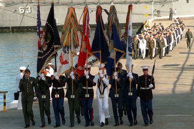 A joint service color guard parades the colors during an observance commemorating the 50th anniversary of the Japanese attack on Pearl Harbor