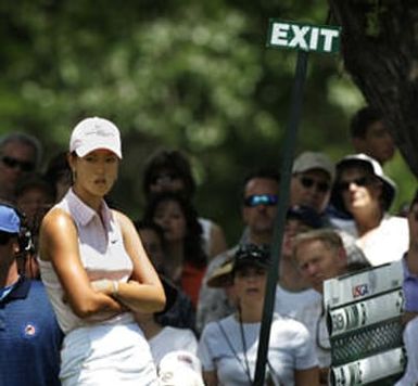 Amateur golfer Michelle Wie, of Honolulu, Hawaii, waits on No. 8 for her playing partner Birdie Kim to putt out during their final round of the 2005 U.S. Women's Open at Cherry Hills Country Club in Cherry Hills Village, Colo., on Sunday, June 26, 2005.