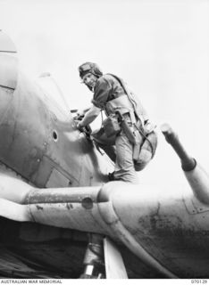 RAMU VALLEY, NEW GUINEA. 1944-01-02. 416062 FLIGHT LIEUTENANT IAN RUSSELL (PIP) OLORENSHAW (1) OF "A" FLIGHT NO. 4 (TACTICAL RECONNAISSANCE) SQUADRON RAAF, ENTERING THE COCKPIT OF A BOOMERANG ..