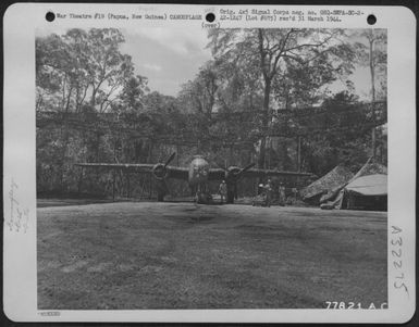 A North American B-25 Under Its Protective Covering Of Camouflage Nets Near Port Moresby, Papua, New Guinea. Nets Are Hung From Trees Around Planes. 27 November 1942. (U.S. Air Force Number 77821AC)