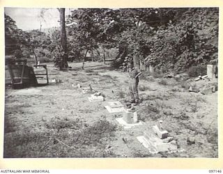 RABAUL, NEW BRITAIN. 1945-09-25. DESECRATED TOMBSTONES IN THE AIF SECTION OF RABAUL CEMETERY. MANY HEADSTONES WERE BROKEN BY THE JAPANESE AND USED IN PILLBOX DEFENCE AND FOR OTHER ODD PURPOSES