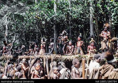 Mendi men kneeling on a platform