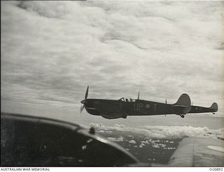 BISMARCK ARCHIPELAGO. 1944-03-28. AIRCRAFT, CODE NAMED UP-T, UP-S, OF NO. 79 (SPITFIRE) SQUADRON RAAF, IN FLIGHT OVER NEW BRITAIN EN ROUTE FROM KIRIWINA TO THE ADMIRALTY ISLANDS. PHOTOGRAPH TAKEN ..