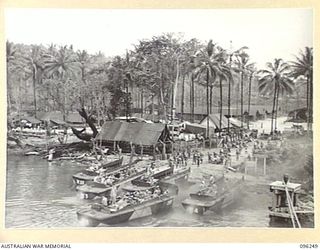 JACQUINOT BAY, NEW BRITAIN. 1945-09-09. TROOPS OF 4 INFANTRY BRIGADE BOARDING BARGES FROM HMAS MANOORA. THE MANOORA CARRIED TROOPS FOR THE OCCUPATION OF THE RABAUL AREA, FOLLOWING THE SURRENDER OF ..