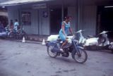 French Polynesia, woman cycling in Papeete