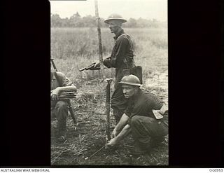AITAPE AREA, NORTH EAST NEW GUINEA. C. 1944-04-22. RIGHT IN THE THICK OF IT MEMBERS OF A RAAF SURVEY AND DESIGN UNIT PEG OUT A NEW STRIP WHILE JAPANESE SNIPERS LURK IN THE JUNGLE. FLIGHT LIEUTENANT ..